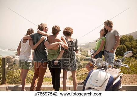 Group of friends, looking at view, rear view View Large Photo Image Stock Image - Group of friends, looking at view, rear view. Fotosearch