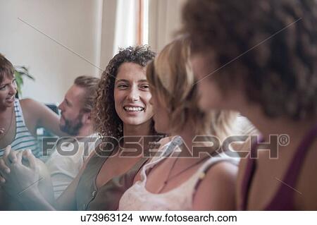 Group of friends, sitting on sofa, relaxing, smiling View Large Photo Image Picture - Group of friends, sitting on sofa, relaxing, smiling. Fotosearch