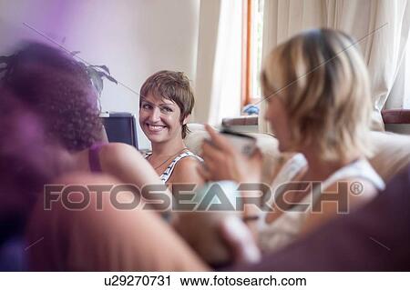 Group of friends, sitting on sofa, drinking tea View Large Photo Image Stock Image - Group of friends, sitting on sofa, drinking tea. Fotosearch
