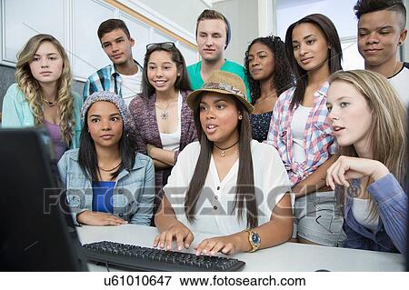 Stock Photo - Group of teenagers working on computer in high school class. Fotosearch