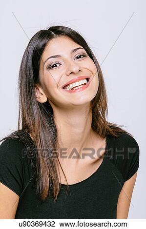 Head and shoulder portrait of young woman looking at camera smiling View Large Photo Image Stock Image - Head and shoulder portrait of young woman looking at camera smiling. Fotosearch