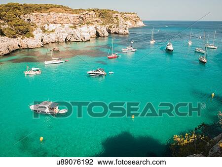 Stock Image - High angle view of yachts anchored in bay at Cala Macarella, Menorca, Spain. Fotosearch