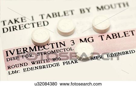 Stock Image - Ivermectin pills (a broad-spectrum antiparasitic agent) on top of instruction label. Fotosearch
