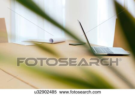 Laptop and smartphone on empty boardroom table View Large Photo Image Stock Photography - Laptop and smartphone on empty boardroom table. Fotosearch