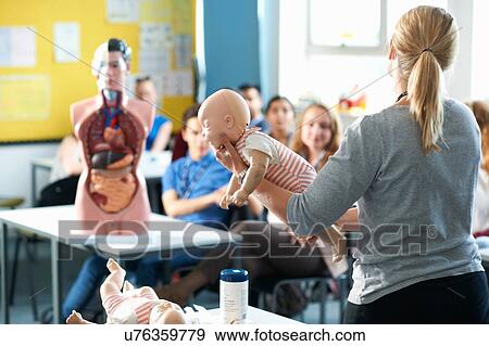 Stock Photo - Lecturer speaking to college students in Childcare class. Fotosearch