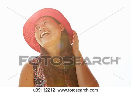 Low angle view of happy mid adult woman wearing sunhat View Large Photo Image Stock Image - Low angle view of happy mid adult woman wearing sunhat. Fotosearch