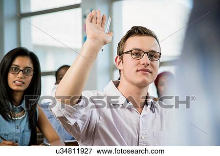 Male student in classroom, hand raised View Large Photo Image Stock Photo - Male student in classroom, hand raised. Fotosearch