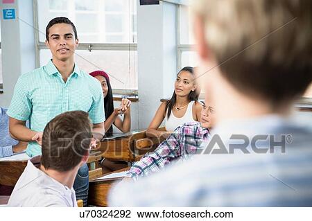 Stock Image - Male student making presentation to class. Fotosearch
