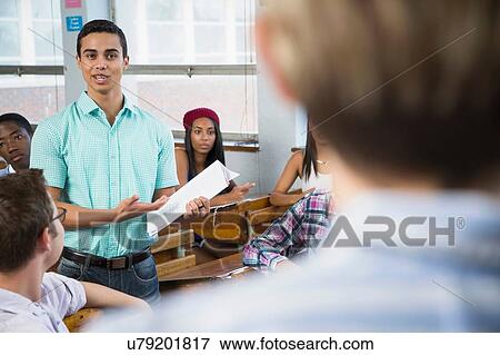 Stock Photo - Male student making presentation to class. Fotosearch