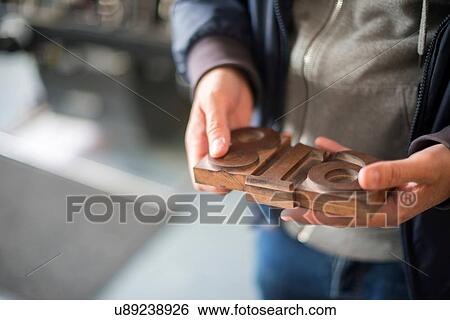 Mans hands holding traditional letterpress numerals workshop View Large Photo Image Stock Photograph - Mans hands holding traditional letterpress numerals workshop. Fotosearch