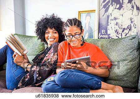 Mature woman and son shoulder to shoulder on living room sofa View Large Photo Image Stock Photo - Mature woman and son shoulder to shoulder on living room sofa. Fotosearch