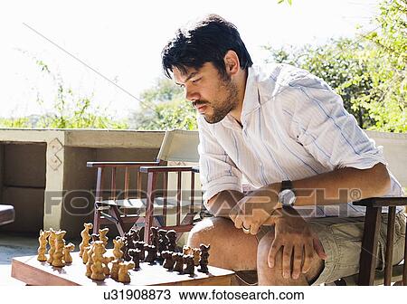 Mid adult man playing chess at safari lodge, Kafue National Park, Zambia View Large Photo Image Stock Image - Mid adult man playing chess at safari lodge, Kafue National Park, Zambia. Fotosearch