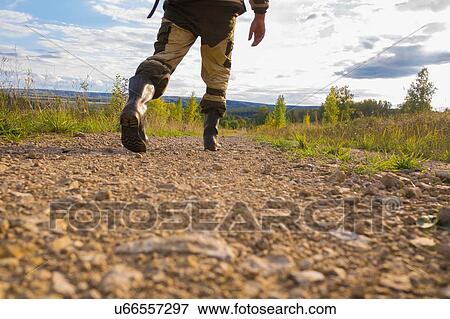Mid adult man walking on dirt path, low section View Large Photo Image Stock Photo - Mid adult man walking on dirt path, low section. Fotosearch