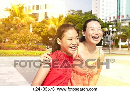 Mid adult woman and daughter strolling, Zhuhai, Guangdong, China View Large Photo Image Stock Image - Mid adult woman and daughter strolling, Zhuhai, Guangdong, China. Fotosearch