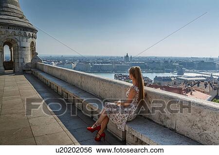 Mid adult woman looking at view of Buda from the Fisherman's Bastion, Budapest, Hungary View Large Photo Image Stock Photograph - Mid adult woman looking at view of Buda from the Fisherman's Bastion, Budapest, Hungary. Fotosearch