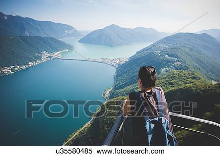 Mid adult woman on balcony looking out at Lake Lugano, Switzerland View Large Photo Image Stock Photography - Mid adult woman on balcony looking out at Lake Lugano, Switzerland. Fotosearch