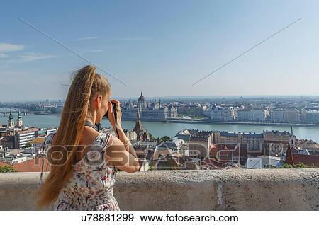 Mid adult woman taking photography of Buda from the Fisherman's Bastion, Budapest, Hungary View Large Photo Image Stock Photo - Mid adult woman taking photography of Buda from the Fisherman's Bastion, Budapest, Hungary. Fotosearch