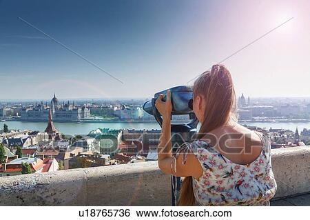 Mid adult woman using viewing binoculars, rear view, Budapest, Hungary View Large Photo Image Stock Photograph - Mid adult woman using viewing binoculars, rear view, Budapest, Hungary. Fotosearch