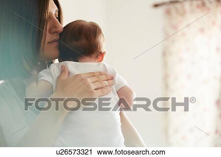 Mother carrying baby in bedroom View Large Photo Image Stock Image - Mother carrying baby in bedroom. Fotosearch