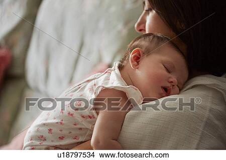 Picture - Mother carrying sleeping baby. Fotosearch