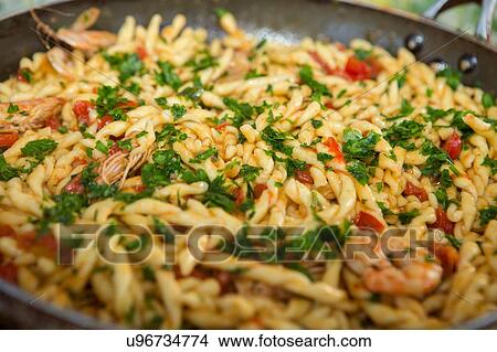 Pan of pasta with tomatoes and prawns View Large Photo Image Picture - Pan of pasta with tomatoes and prawns. Fotosearch