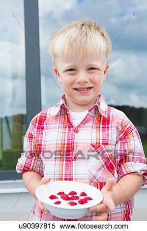 Portrait of boy on patio with bowl of raspberries View Large Photo Image Stock Photography - Portrait of boy on patio with bowl of raspberries. Fotosearch