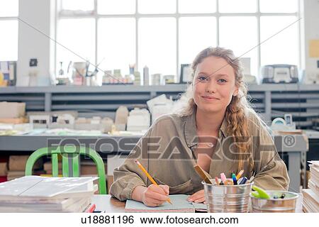 Portrait of female print designer working on sketchbook in workshop View Large Photo Image Stock Photograph - Portrait of female print designer working on sketchbook in workshop. Fotosearch