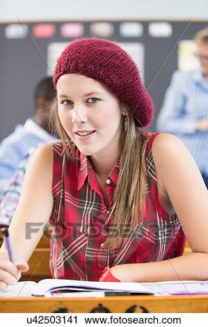 Portrait of female student, sitting at desk in classroom View Large Photo Image Stock Image - Portrait of female student, sitting at desk in classroom. Fotosearch