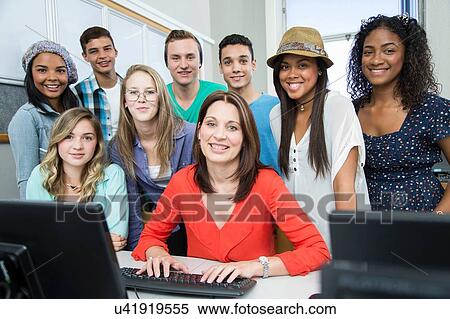 Portrait of female teacher and high school students in computer class View Large Photo Image Stock Photography - Portrait of female teacher and high school students in computer class. Fotosearch