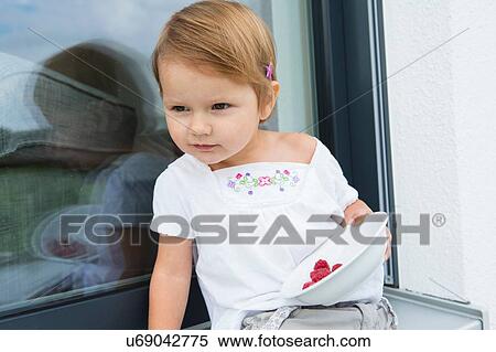 Portrait of female toddler on patio eating bowl of raspberries View Large Photo Image Stock Photography - Portrait of female toddler on patio eating bowl of raspberries. Fotosearch