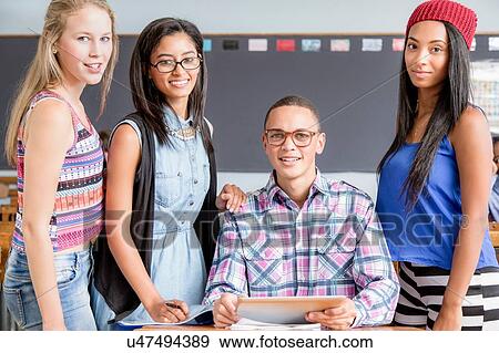 Portrait of four students in classroom View Large Photo Image Stock Photo - Portrait of four students in classroom. Fotosearch