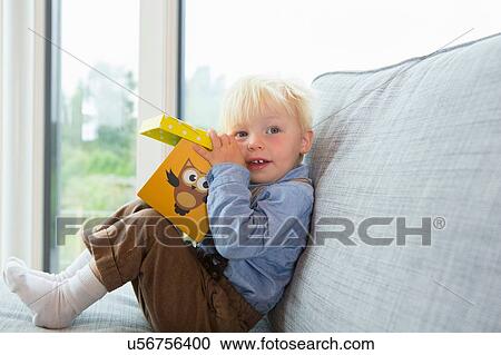 Portrait of male toddler playing with building blocks on sofa View Large Photo Image Stock Image - Portrait of male toddler playing with building blocks on sofa. Fotosearch