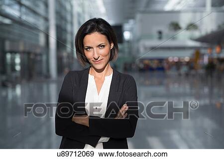 Portrait of mature businesswoman with arms folded at airport View Large Photo Image Stock Photo - Portrait of mature businesswoman with arms folded at airport. Fotosearch