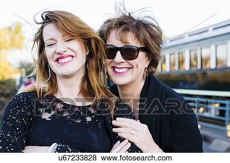 Stock Photo - Portrait of mature woman and daughter on vacation. Fotosearch