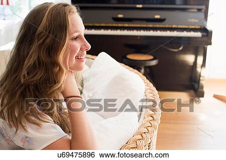 Stock Photograph - Portrait of pretty teenage girl in sitting room. Fotosearch