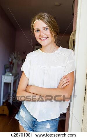 Portrait of pretty teenage girl leaning against doorway View Large Photo Image Stock Image - Portrait of pretty teenage girl leaning against doorway. Fotosearch