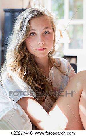Portrait of pretty teenage girl on sofa View Large Photo Image Stock Photograph - Portrait of pretty teenage girl on sofa. Fotosearch