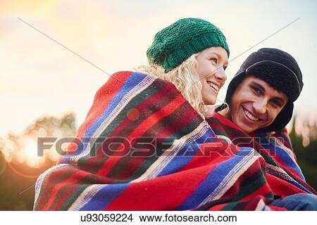 Portrait of romantic young camping couple wrapped in blanket View Large Photo Image Picture - Portrait of romantic young camping couple wrapped in blanket. Fotosearch
