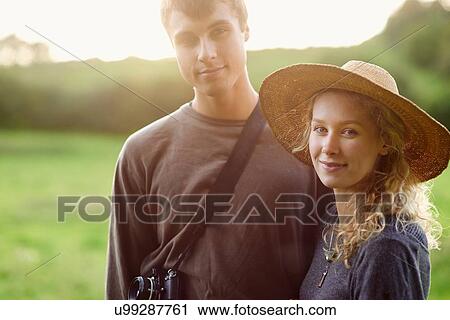 Portrait of romantic young couple in rural field View Large Photo Image Stock Image - Portrait of romantic young couple in rural field. Fotosearch