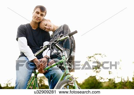Portrait of romantic young couple with bicycle View Large Photo Image Stock Image - Portrait of romantic young couple with bicycle. Fotosearch