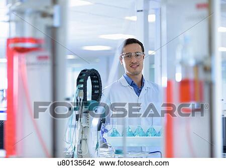 Portrait of scientists inspecting coloured samples in testing laboratory View Large Photo Image Stock Image - Portrait of scientists inspecting coloured samples in testing laboratory. Fotosearch