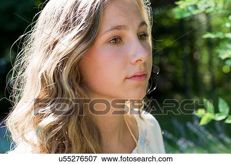 Stock Photo - Portrait of serene teenage girl in garden. Fotosearch