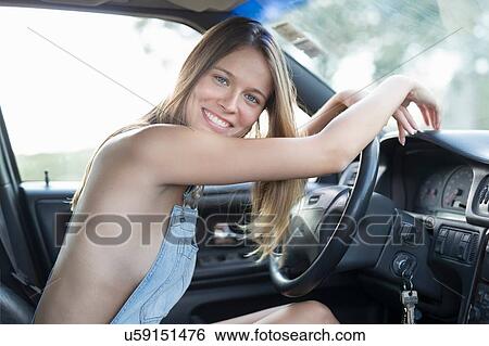 Portrait of sexy young blond woman at car steering wheel View Large Photo Image Stock Photograph - Portrait of sexy young blond woman at car steering wheel. Fotosearch