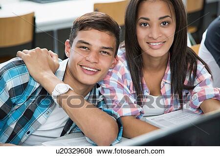 Stock Photo - Portrait of teenage boy and girl in high school computer class. Fotosearch