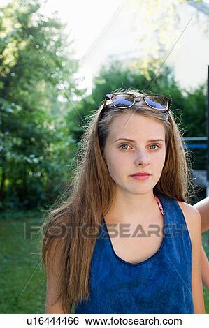 Portrait of teenage girl with long brown hair in garden View Large Photo Image Stock Photograph - Portrait of teenage girl with long brown hair in garden. Fotosearch