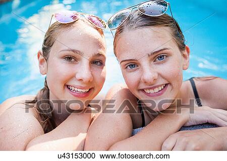 Portrait of two pretty teenage girls at poolside View Large Photo Image Stock Image - Portrait of two pretty teenage girls at poolside. Fotosearch