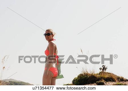 Portrait of woman wearing bikini in dunes, Menorca, Spain View Large Photo Image Stock Photo - Portrait of woman wearing bikini in dunes, Menorca, Spain. Fotosearch