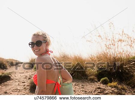 Portrait of woman wearing bikini top in dunes, Menorca, Spain View Large Photo Image Stock Photograph - Portrait of woman wearing bikini top in dunes, Menorca, Spain. Fotosearch
