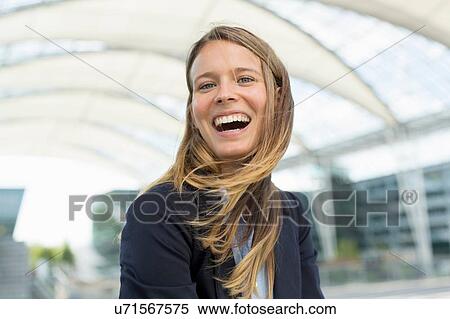 Stock Photography - Portrait of young businesswoman laughing. Fotosearch