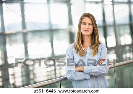 Portrait of young businesswoman with arms folded View Large Photo Image Stock Photography - Portrait of young businesswoman with arms folded. Fotosearch